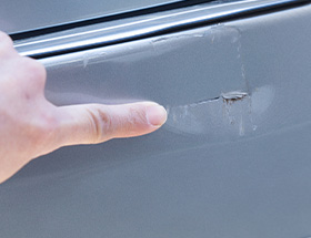 へこんだ車のボディの画像